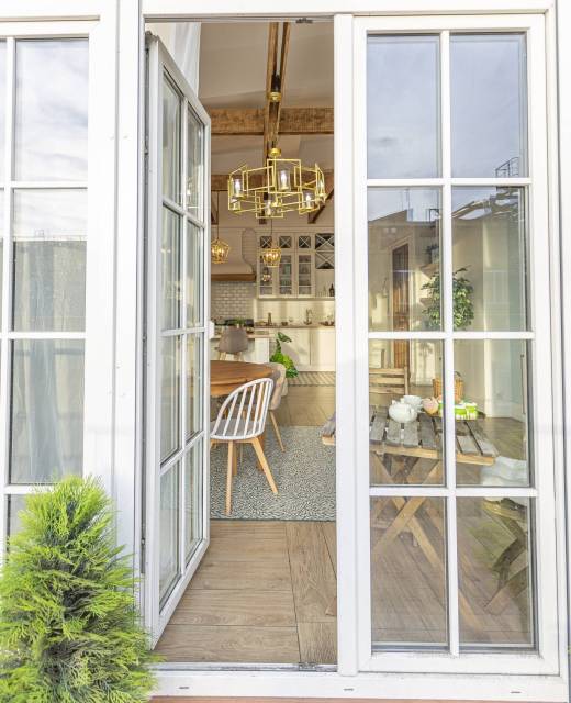 modern expensive luxurious open-plan apartment. Rich Scandinavian-style interior with wooden beams on the ceiling in pastel colors